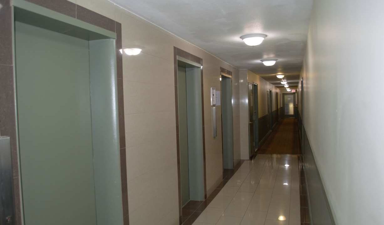 135 - Carpeted Hallway with elevator landing samll